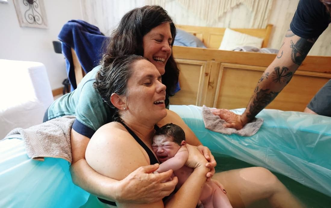 A beautiful water birth moment showing the joy of new life