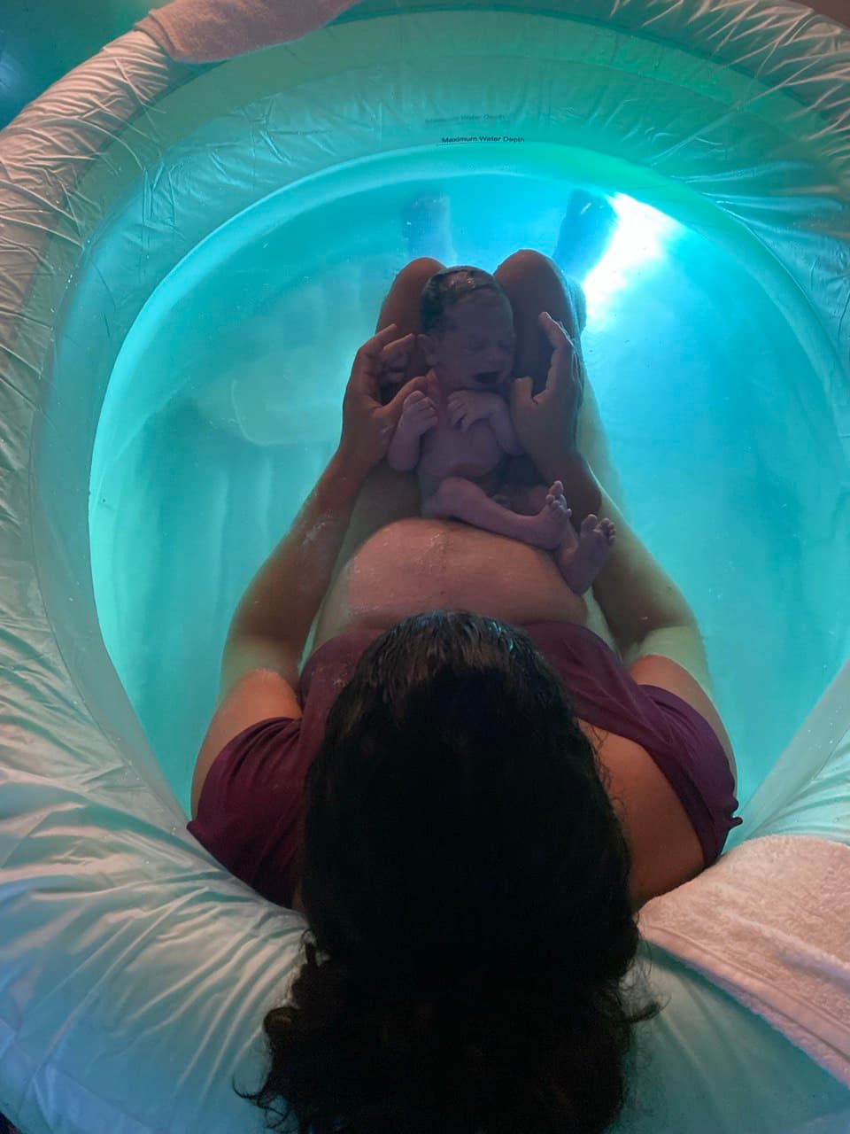 A touching moment during water birth with birth team support
